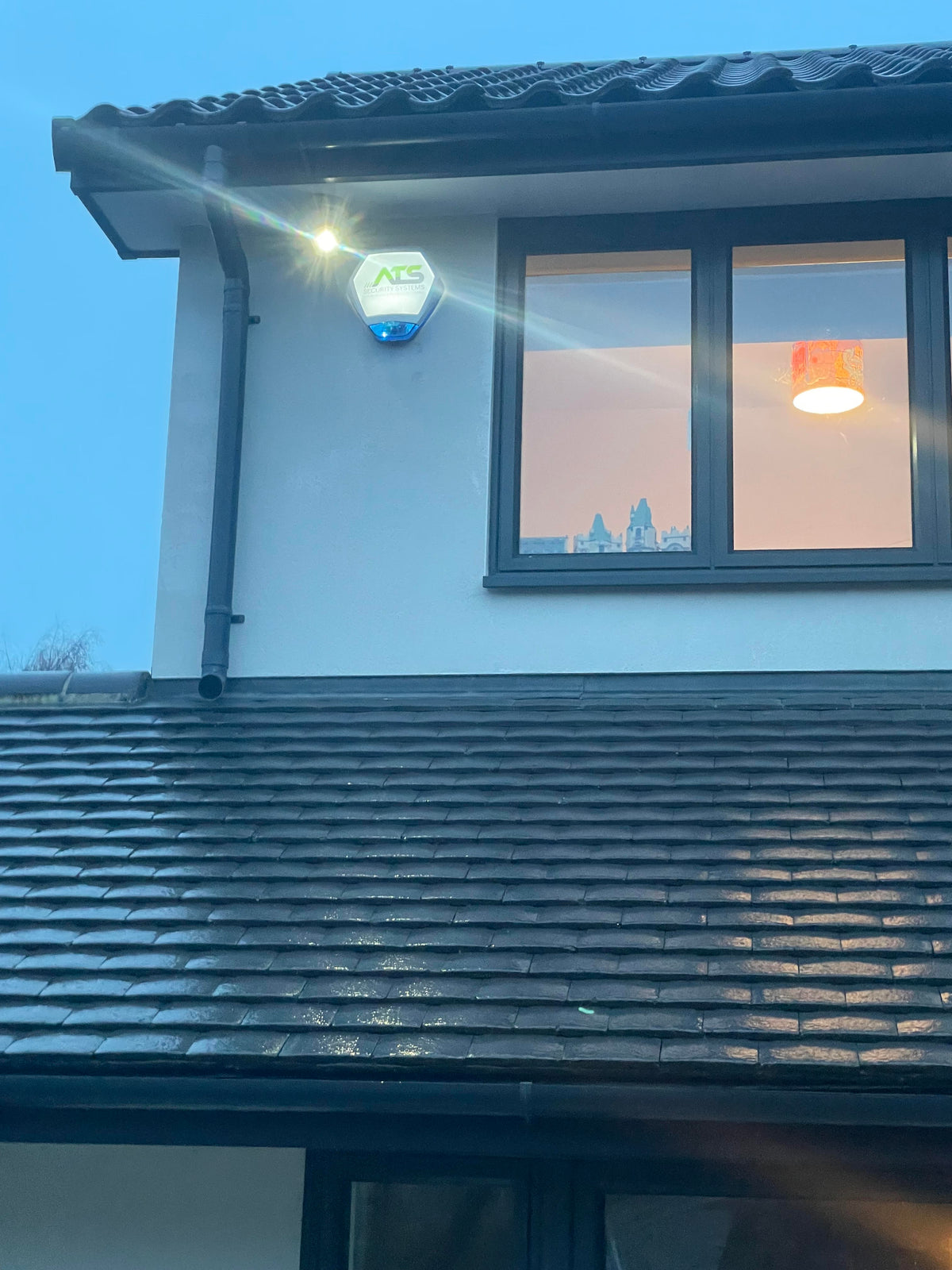 External security lighting installed alongside an ATS alarm system.